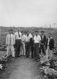 W. Edwards Deming tours a field of crops with Japanese executives in 1950