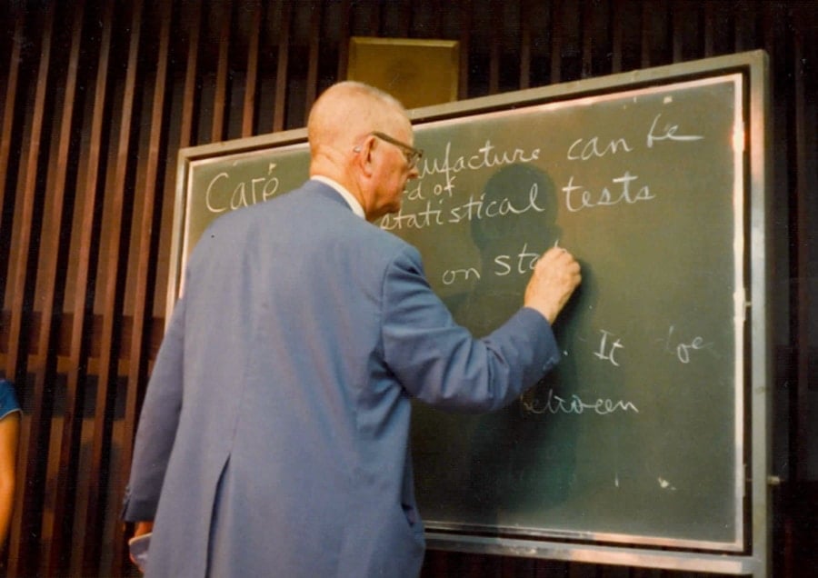 W. Edwards Deming writing on chalkboard (about statistical testing) - 1980s