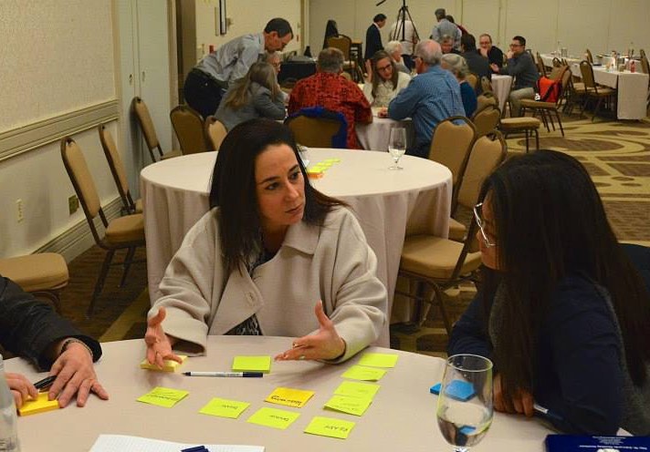 people working and discussing at their tables