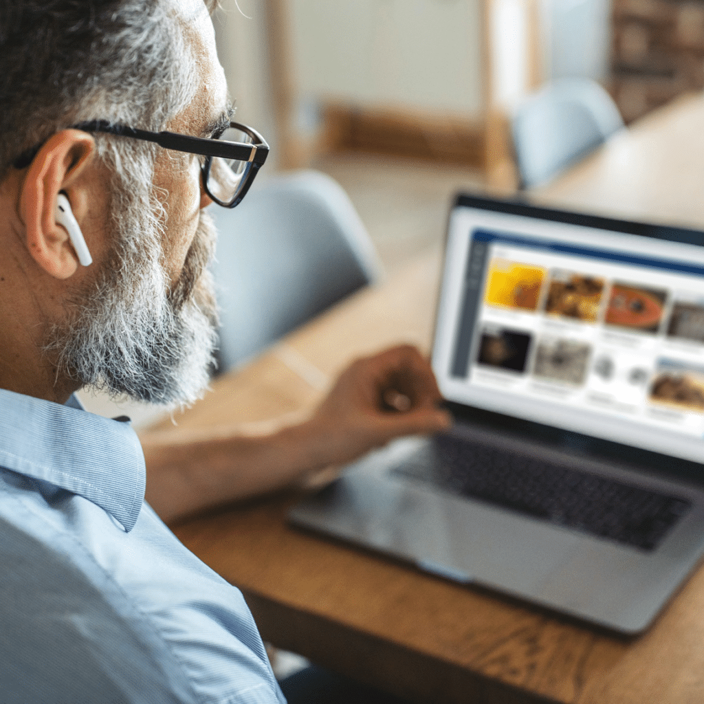 Man looking at DemingNext on computer